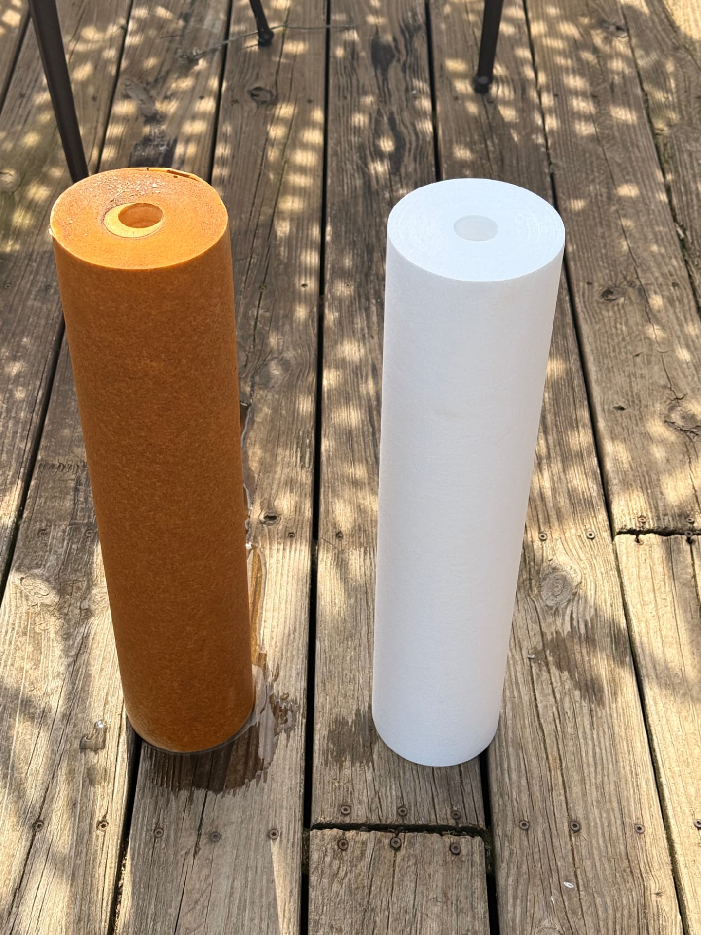 Iron-stained sediment cartridge next to a fresh one
