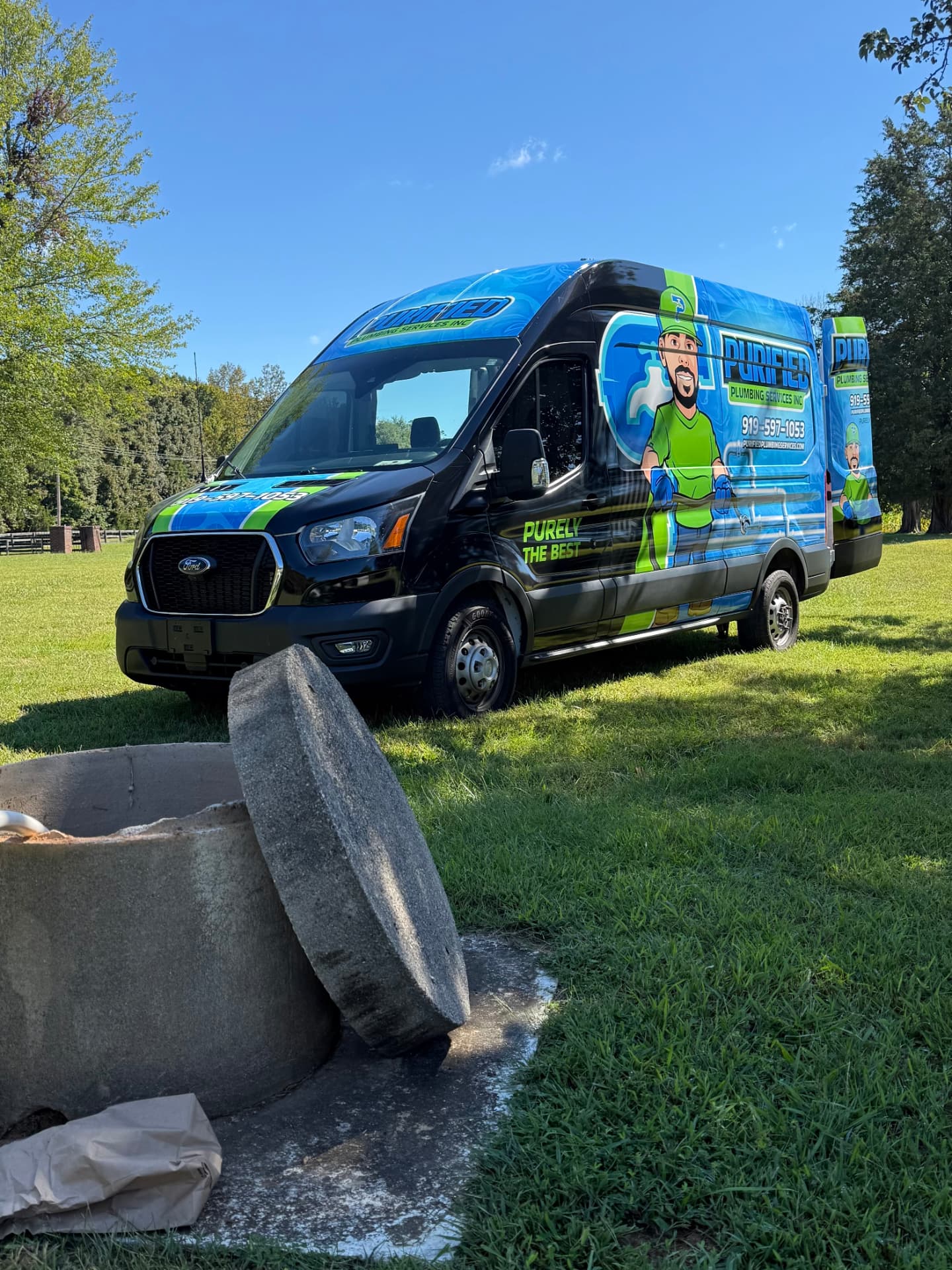 Open septic tank access with the Purified Plumbing van on site