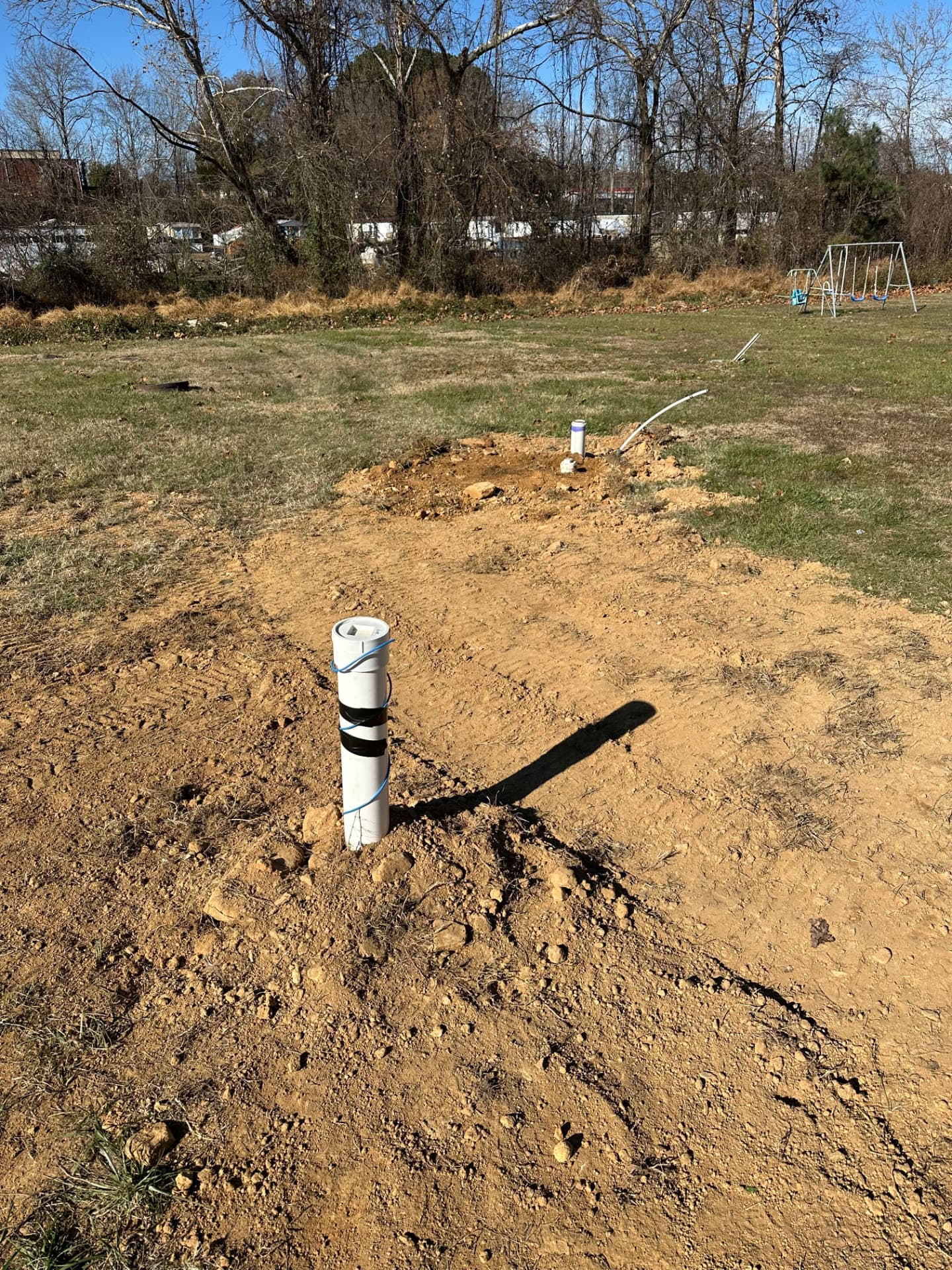 Sewer cleanout stub installed and backfilled in a yard trench