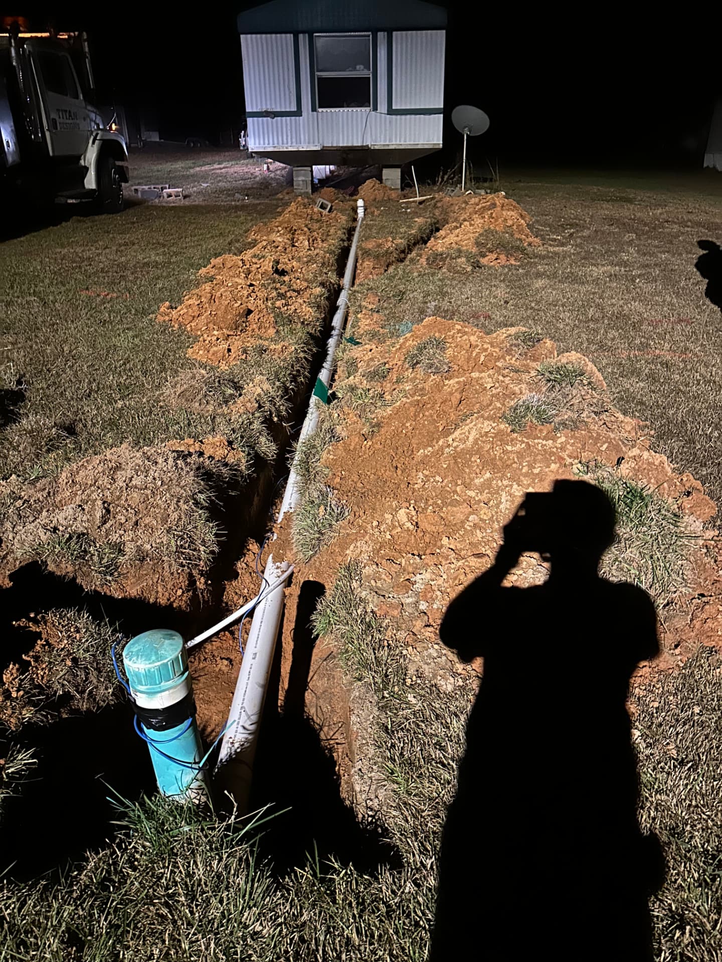 Night trench repair on an underground line with the well head exposed